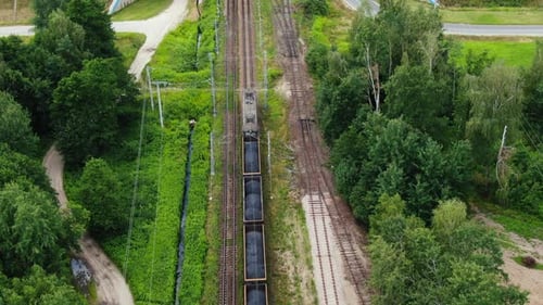 Freight Train Traveling Through Green Rural Landscape