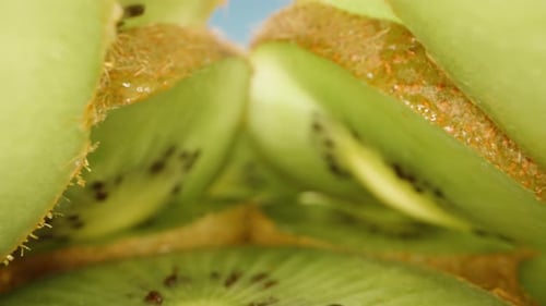 Kiwi slices, the camera inside slides between the slices. Dolly slider extreme close-up.
