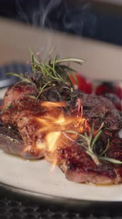 Delicious steak dinner is prepared with herbs