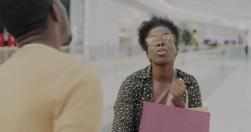 Slow Motion Portrait of Happy African American Lady Dragging Man to Shopping Mall Talking to