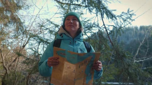 Woman Holds Map in Forest Adventure