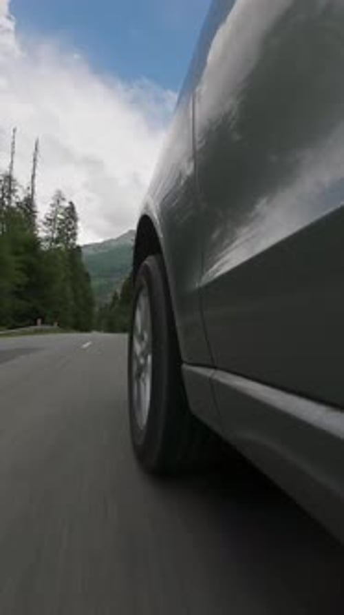 Car Driving on Scenic Road Side View