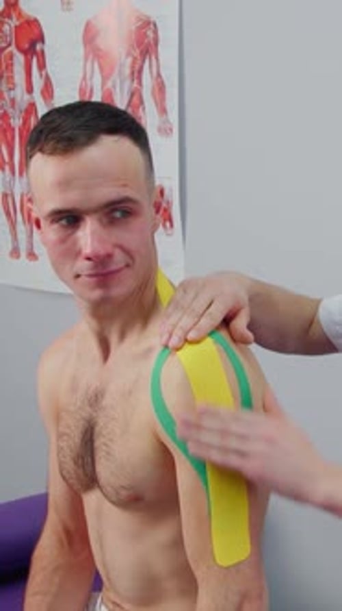 Man Getting Shoulder Taped in a Clinic