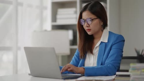 Businesswoman is seriously stressed working feel eye ache headache due to office syndrome.