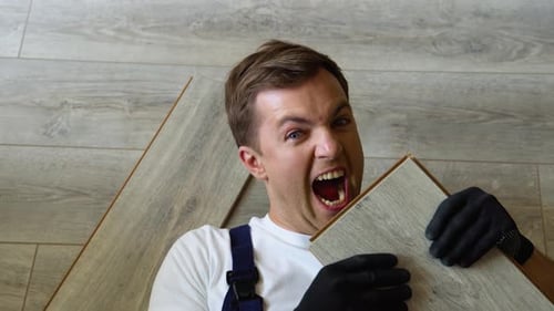 Funny Man Lying on Floor with Wood Planks