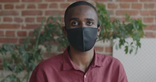 Portrait of Young Man Company Employee Standing in Office Wearing Face Mask During Coronavirus