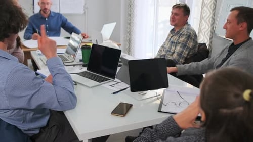 Business Team Meeting Leadership Team Engaging in Strategic Planning with Laptops During Meeting an
