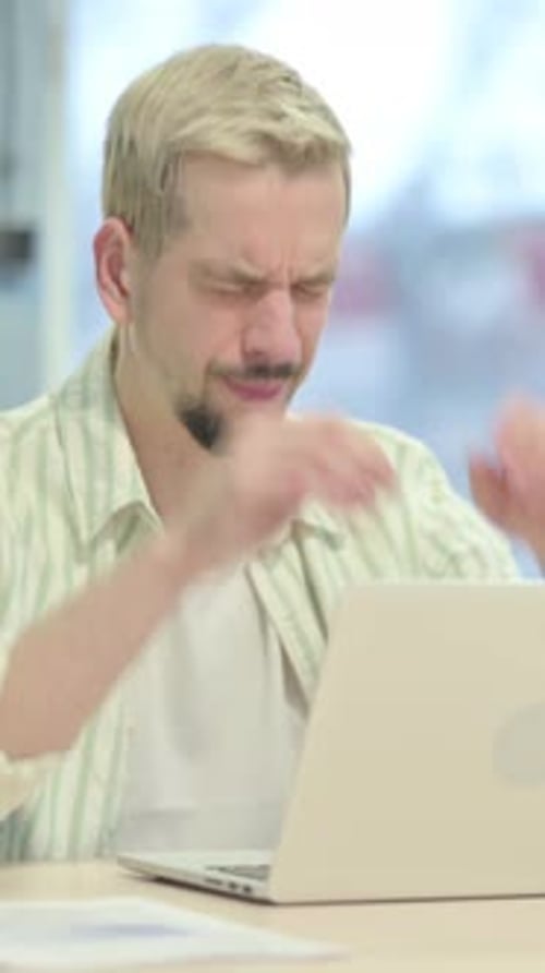 Man Working on Laptop at Desk Having Headache