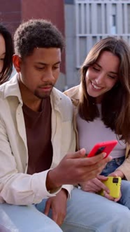 Friends Laughing at Phone Content Together Outside