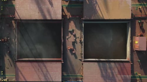 Aerial View of Big Cargo Ship Bulk Carrier is Loaded with Grain of Wheat in Port at Sunset