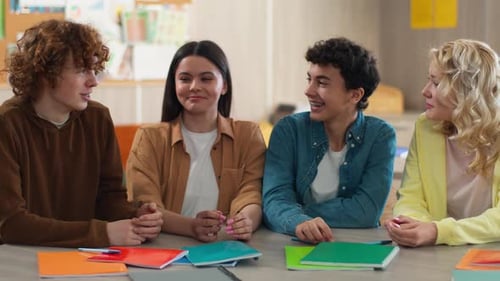 Teen Students Talking Together at School Table
