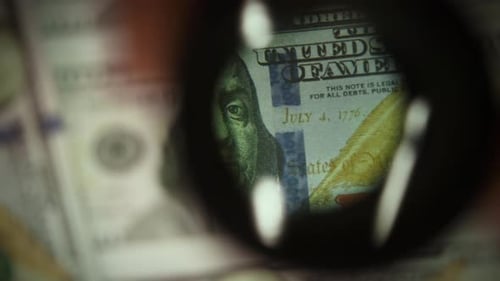 Magnifying Glass Analyzes One Hundred Dollar Bill