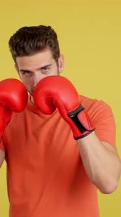 Young Adult Punching with Red Boxing Gloves