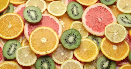 Top Down Background View Made of Fresh Sliced Organic Kiwi Oranges and Lemons Closeup