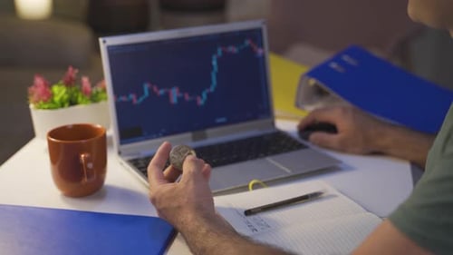 Adult Trading Cryptocurrency Using Laptop At Home