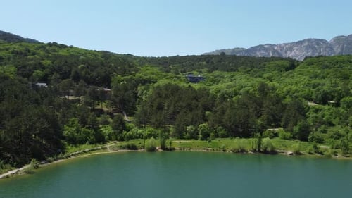 Aerial View on Mountain Lake with Turquoise Water and Green Trees