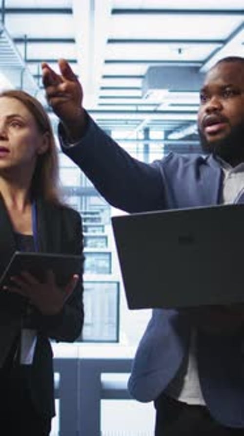Vertical Video Coworkers in Data Center Doing Brainstorming Fixing Errors