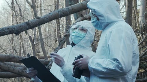 Forensic Specialist Working in the Forest Police Criminalists Collecting Evidence and Making