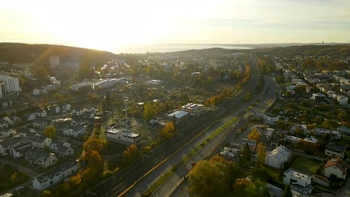Retour aérien au-dessus du quartier résidentiel privé de la ville de Gdynia au lever du soleil avec autoroute et pluie