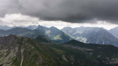 Majestic mountain landscape with dramatic clouds over lush valleys in Europe