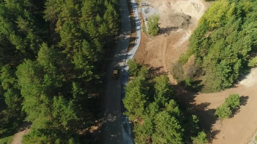 Excavator Moves Down Highway Towards Construction Zone