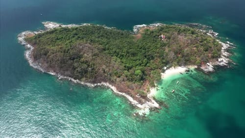 Aerial view of the heart shaped island in the tropical sea. Camera orbits