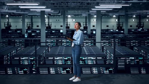 Side View Of Full Body Asian Business Woman Using Tablet An Looking Around In Data Center