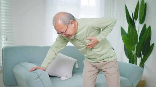 Senior Man with Heart Attack Suffering Indoor at Home