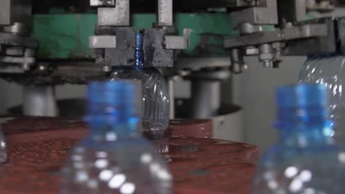 Close Up Empty Plastic Bottles are Moved on a Conveyor Belt