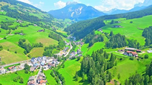 Aerial of Quaint Town of St. Magdalena with Alps Backdrop, Dolomites, Italy