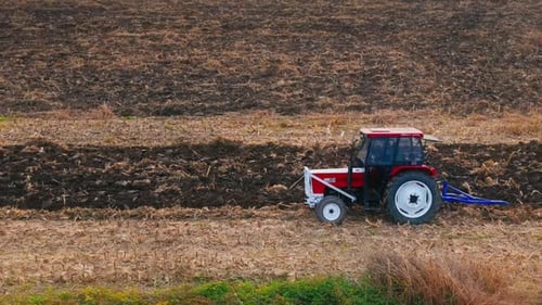 Farm Tractor Plowing Field