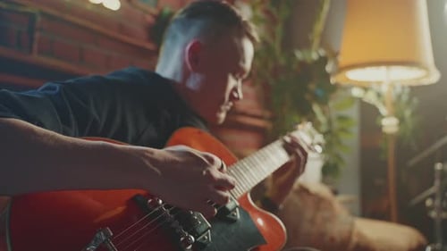 Man Plays Electric Guitar in Living Room