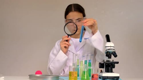 Teen Scientist Examining Blue Liquid in Test Tube