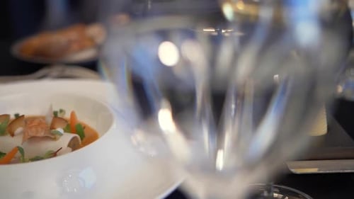 Luxurious fine-dining dish being served. Sliding shot.