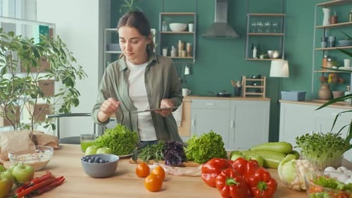 Woman with Tablet Surrounded by Fresh Vegetables