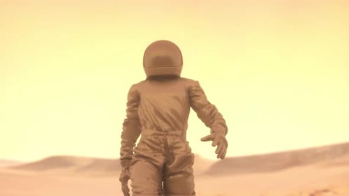 Astronaut Walking Alone on Alien Desert Planet With Warm Light