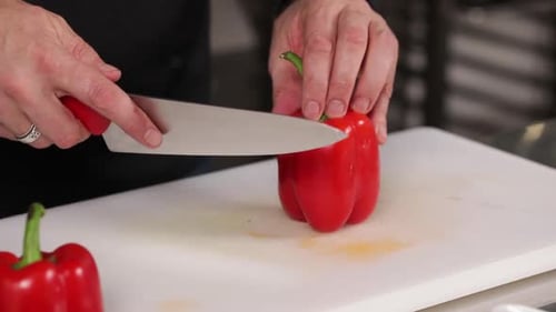 Chef Cuts a Red Pepper on Cutting Board