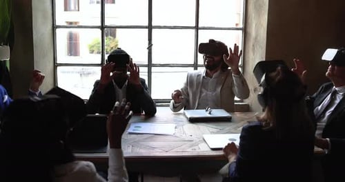 Business team immersed in the metaverse using vr goggles inside modern office