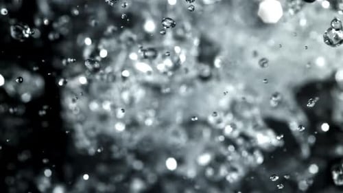 Water Droplets Exploding Upward in a Close Up View