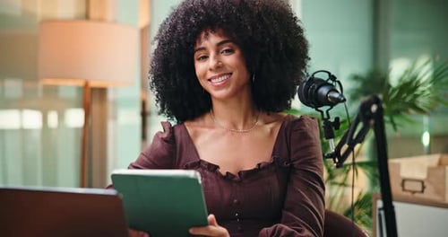 Woman with Tablet Smiling at Camera Indoors