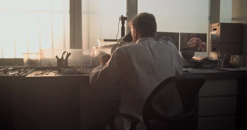 Scientist Works With Microscope in Paleontology Lab