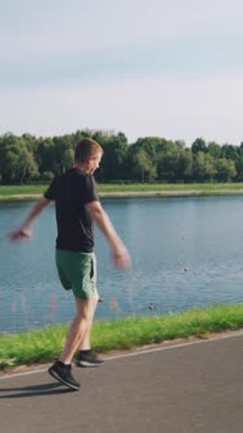 Man Stretching Before Run Next to Pond