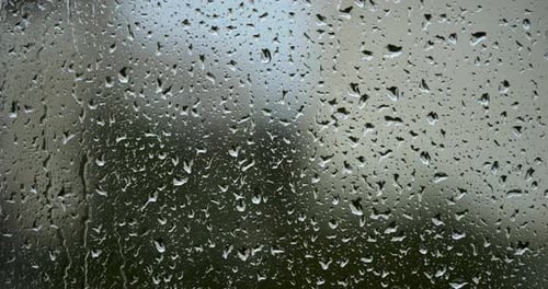 Raindrops on Window Glass Close Up View