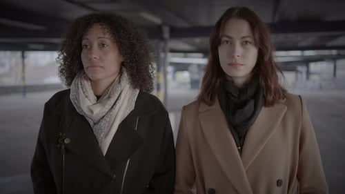 Lifestyle Portrait of Two Young Women Watching Tower Building Together