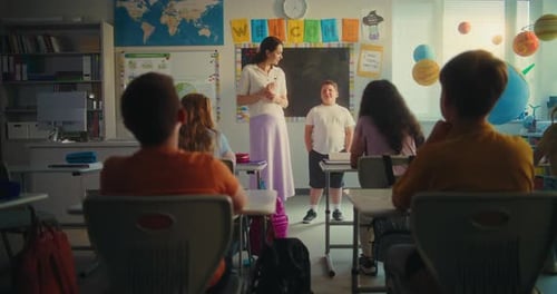 Elementary School Student Speaking About Energy Sources in Front of Classroom