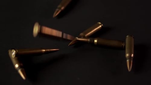 Golden Cartridges From an Automatic Rifle on a Black Background