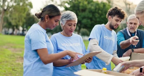 Volunteers Packing Boxes in Urban Park Setting