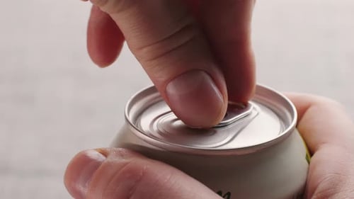 Opening Soda or Beer Can Macro Close Up of Can Pull Tab Opening Watering Refreshment Hand Open