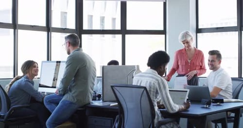 Colleagues, coworking and office with computers, conversation and diversity in workplace