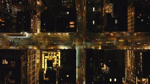 Aerial Views Capture Cars Navigating a Manhattan New York City Intersection at Night Showcasing